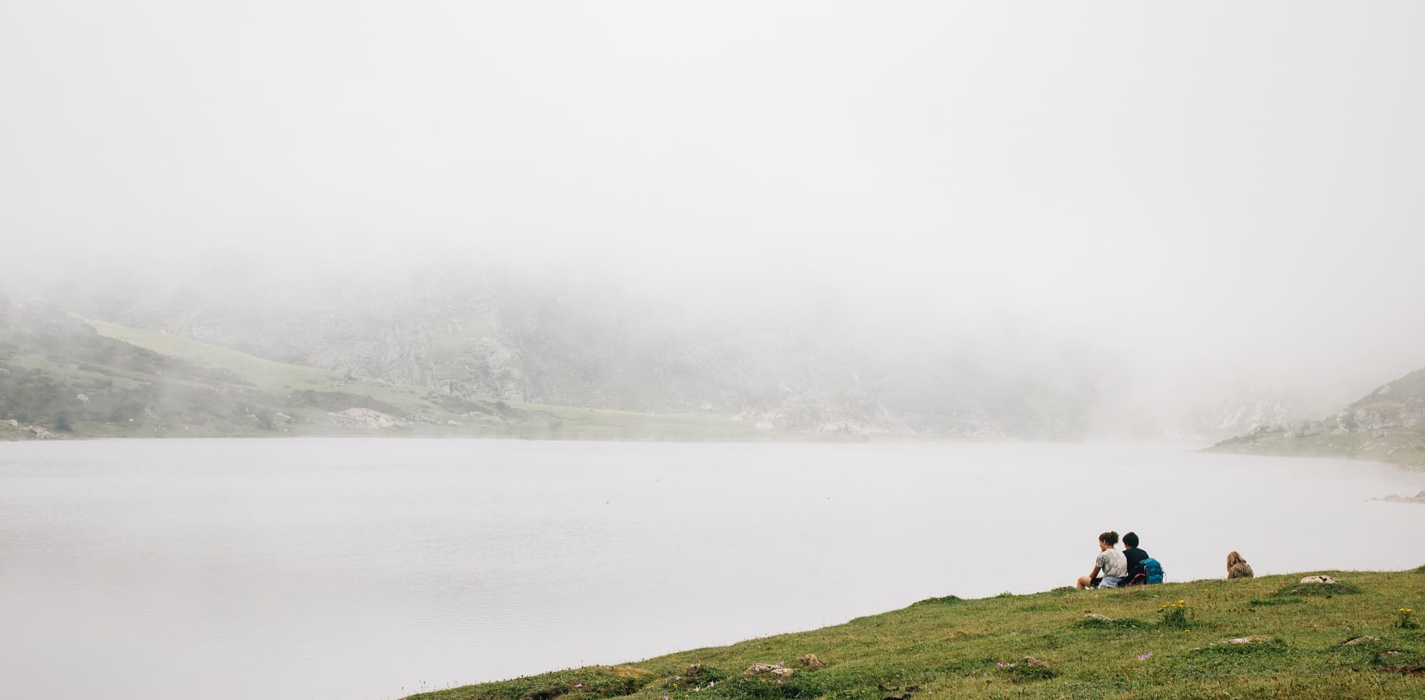 mesmerizing view foggy lake with people sitting